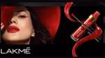 A model with long dark hair and a red hat wears Lakmé Absolute liquid lip colour in a bold red, with red winged eyeliner.