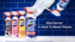 An ad showing a row of four Domestos Power Foam bottles on a white counter in front of a blue-tiled wall. Next to them is an upturned bottle with Power Foam being sprayed from the bottle onto the wall.