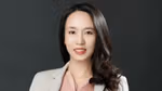 Erica Liang, a scientist at the Pond’s Skin Institute. Erica has long dark hair, a pink blouse and a white lab coat