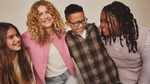 A pic from a Dove campaign of four young teenagers smiling and laughing together. There are three girls and one boy.