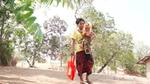 Lady with a baby in her arms carrying a Knorr shopping bag