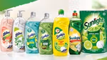 A selection of Sunlight bottles, tablets and packages with a sunburst in the background.