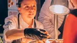 A Unilever Food Solutions chef smiling as she plates up.