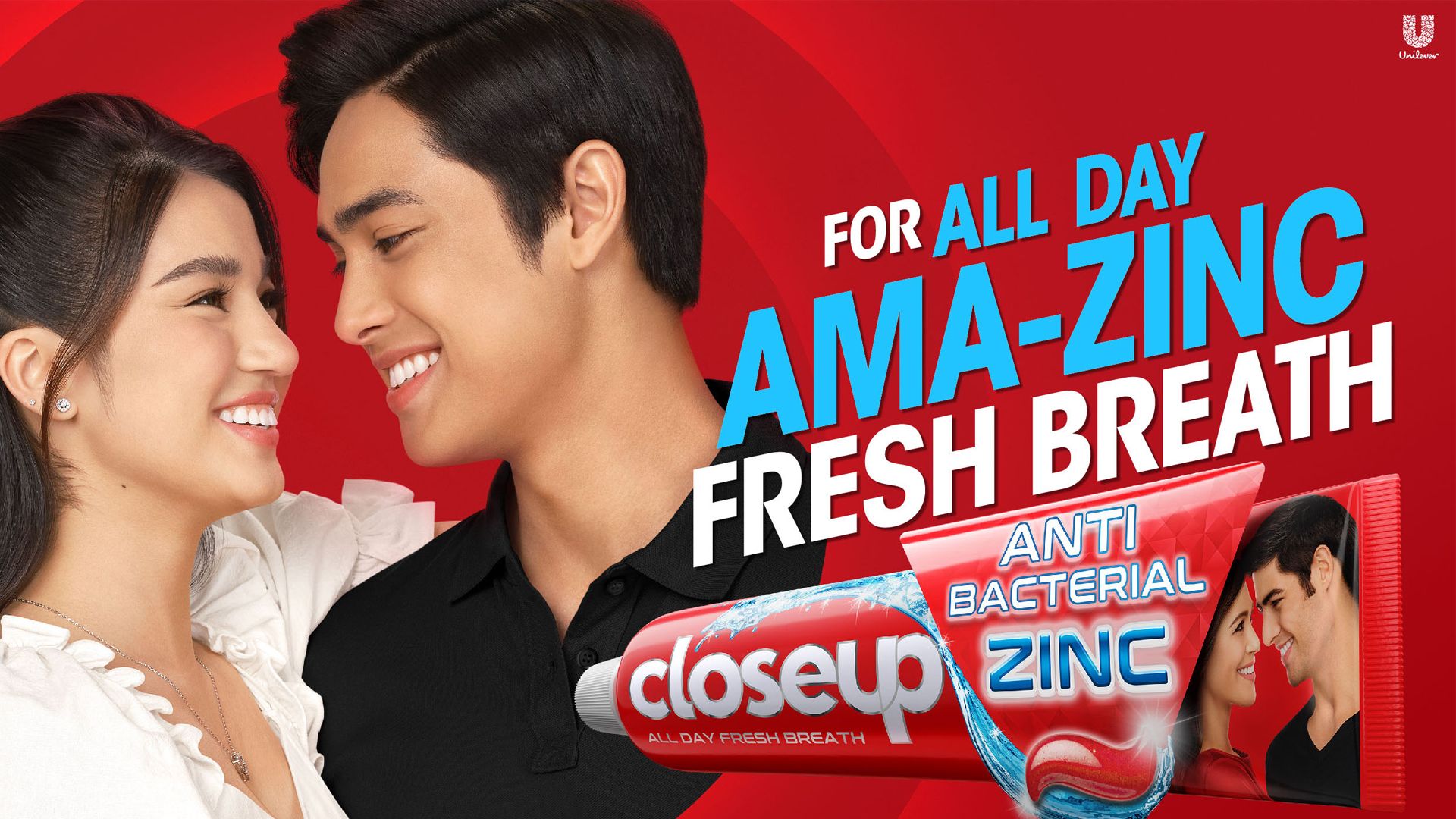 A couple embracing on the left-side of the image. On the right, in the foreground, is a tube of Closeup Antibacterial Zinc toothpaste. The text above that reads: “for all day ama-zinc fresh breath”.