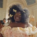 A woman wearing a ruffled pastel dress in an ornate ballroom. Dove has collaborated with Netflix series Bridgerton.